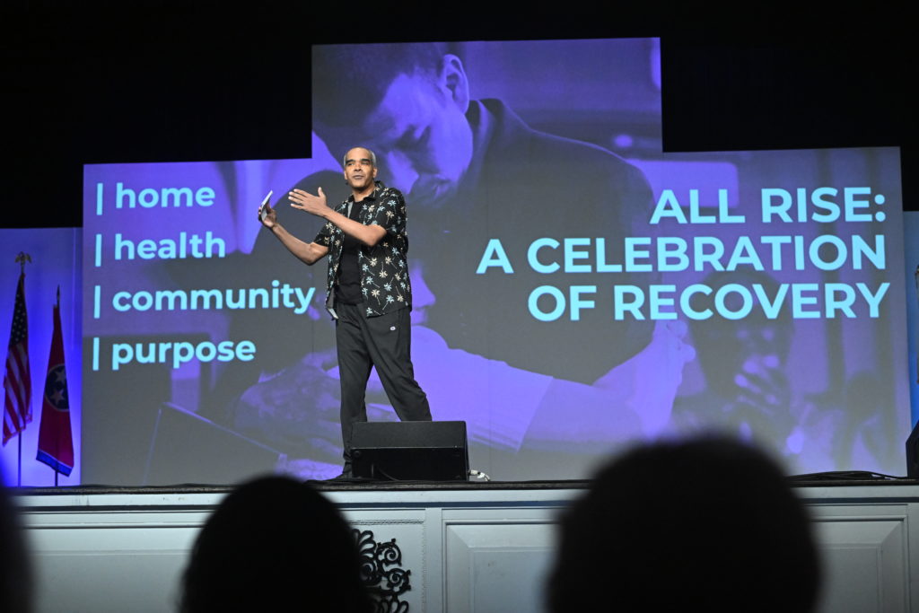 Comedian Dion Flynn welcomes attendees to All Rise: A Celebration of Recovery. 